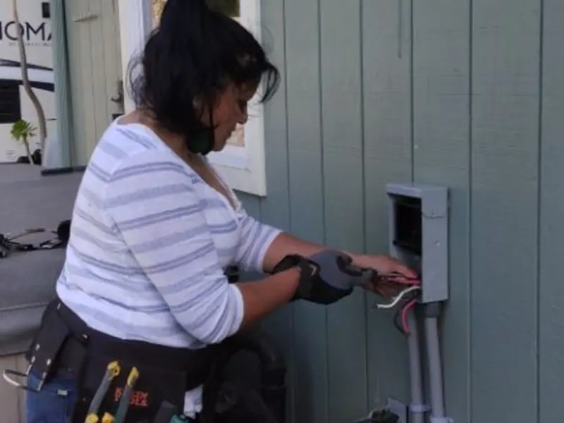 Licensed electrician wiring an exterior subpanel in Checotah